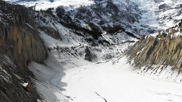 Aerial drone shot of the Glacier between Annapurna and Gangapurna Mountains with drone coming down and back to ground level in Manang valley, Nepal.