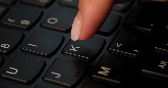 Pushing K button on the black keyboard. English letters. Used Macro lens and slow-mo.