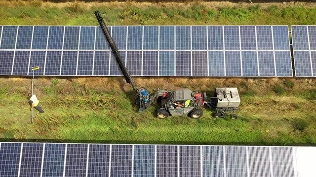 Solar Farm, Machinery And Man Cleaning Panels, Truck Left