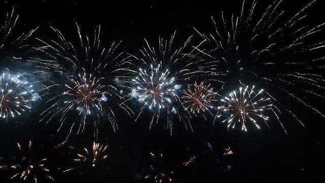 4K abstract fireworks show on deep black night sky