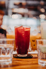 Water bottles and drinking glasses on top of wooden table
