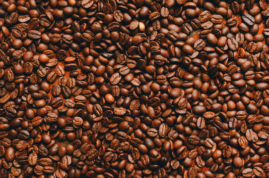 Coffee beans on the rustic background. Selective focus. Shallow depth of field. © maxandrew
