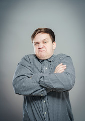 Portrait of disgusted man looking at the camera