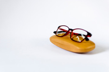 Fototapeta na wymiar eyeglass placed on its wooden case