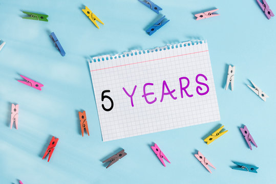Writing note showing 5 Years. Business concept for Remembering or honoring special day for being 10 years in existence Colored clothespin rectangle shaped paper blue background - Powered by Adobe