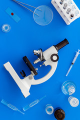 Microscope medical reserch. Blood sample for analysis. Blue table top view