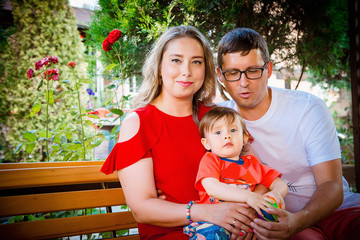 Young average family of three on vacation by the sea