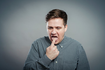 young man with finger in mouth