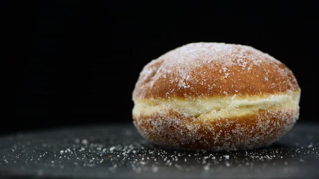 Fresh made Berliner Doughnuts rotating on a plate (seamless loopable)