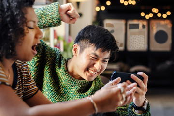Couple playing online mobile game