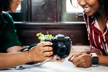 Women inspecting a camera