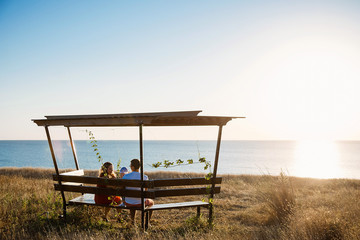 Young average family of three on vacation by the sea