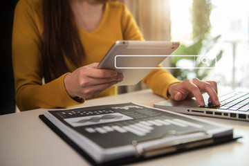 Female businessman using digital tablet analyzes business data, busy working on laptop computer with smart phone and business report on office desk, business strategy analysis concept.