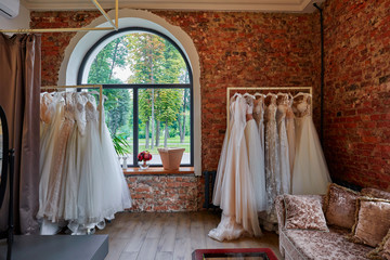 Obraz na płótnie Canvas Collection Of Wedding Dresses In The Shop