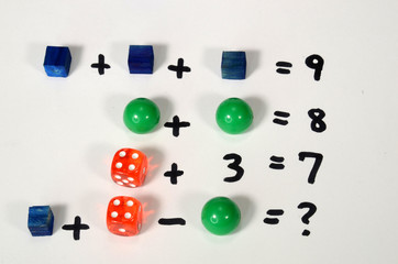 Calculation riddle arrangement with colored objects.