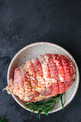 meat pork in roasting net (tasty and healthy raw meat food) menu keto or paleo concept. background. top view. copy space for text