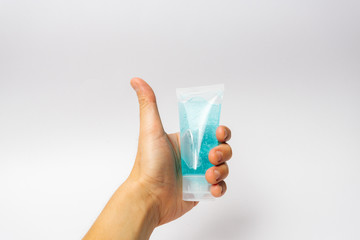 A hand holding hand sanitizer gel for hand hygiene spread protection. Coronavirus corona virus prevention travel.