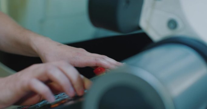 cnc screenshot. cnc machine management screen. laser cutting machine. man pushes buttons on cnc machine. Filmed on RED EPIC-W 4K camera. Close-up