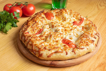 khachapuri closeup with meat on a wooden table. Dish of Georgian cuisine