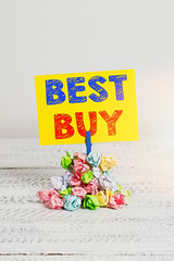 Handwriting text Best Buy. Conceptual photo most advantageous combination of cost and quality of a product Reminder pile colored crumpled paper clothespin reminder white wooden space