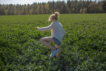 Girl walks  a cucumber field