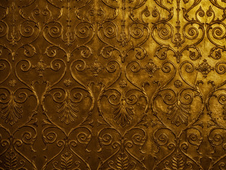 Old golden ornament on the wall