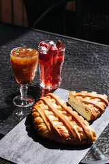 Orange iced coffee and pear cake, summer cold drink in cafe on street, menu.