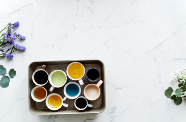 Aerial view of many different cups of beverages