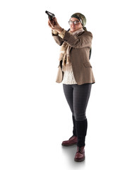 A full-length woman in a jacket, trousers, leggings and with a scarf around her neck holds a gun in her hands isolated on a white background. A head scarf is tied around his head.