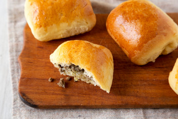 Home-baked Beef Russian Bierocks on a rustic wooden board, low angle view. Close-up.