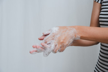 Fototapeta premium Mom shows daughter proper way to wash hands.
