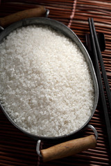 close up Japanese rice in measuring cup on table, Japanese rice in kitchen background