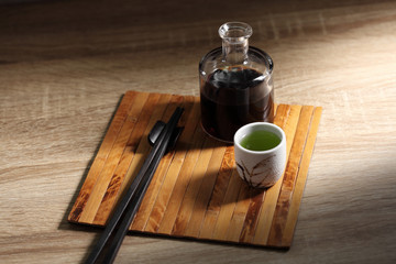 Chopsticks and green tea on wooden table, Japanese utensil in rustic backgrounds