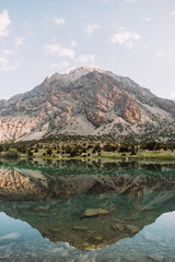 Tajikistan. Fann mountains. Summer. Beautiful mountain landscape. A large mountain is reflected in a mountain lake. Blue and green tones photos