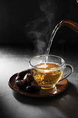 Arab tea and dates fruit  on a concrete background with a blank space for a text