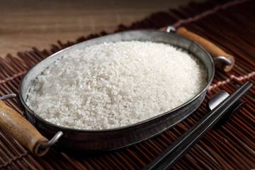 close up Japanese rice in measuring cup on table, Japanese rice in kitchen background