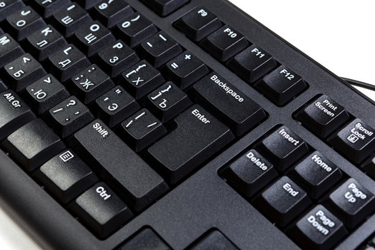 electronic collection - detail black computer keyboard with key enter, with russian letter, closeup, white background