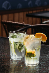 Citrus mojito made from lime and orange. Fresh summer drinks with ice.