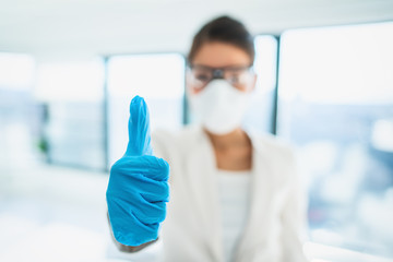 Coronavirus success happy news lab researcher doing thumbs up with medical gloves for vaccine. PPE...