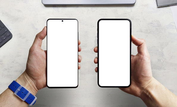 Man hand comparing two new smartphone