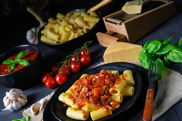Rigatoni pasta with Bolognese sauce and fresh basil