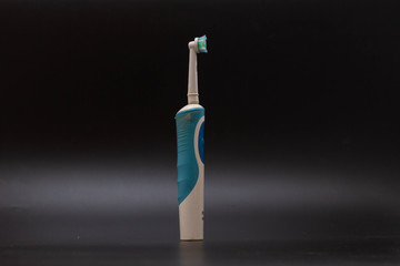 Automatic toothbrush, oral hygiene, black background