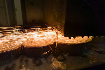 Grinding a metal surface on a surface grinding machine with a water-cooled abrasive stone.