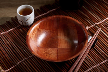 Chopsticks and cup on wooden table, Japanese utensil in rustic backgrounds