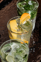 Citrus mojito made from lime and orange. Fresh summer drinks with ice.