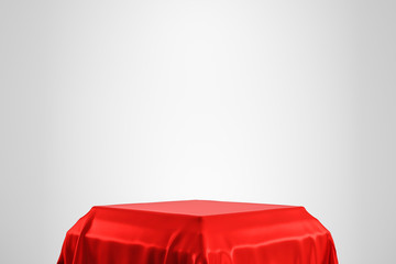 Red luxurious fabric placed on top pedestal or blank podium shelf on white background with luxury...