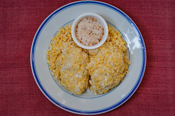 Soft mung bean crepe sprinkled with grated coconut and sugar.