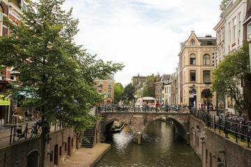 Fototapeta na wymiar Utrecht Canal with a stone bridge and trees around