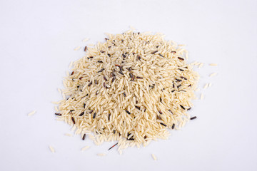 Integral, brown rice pile isolated on white background, top view