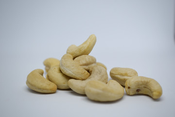 Handful of cashew nuts on a white background, dried fruit